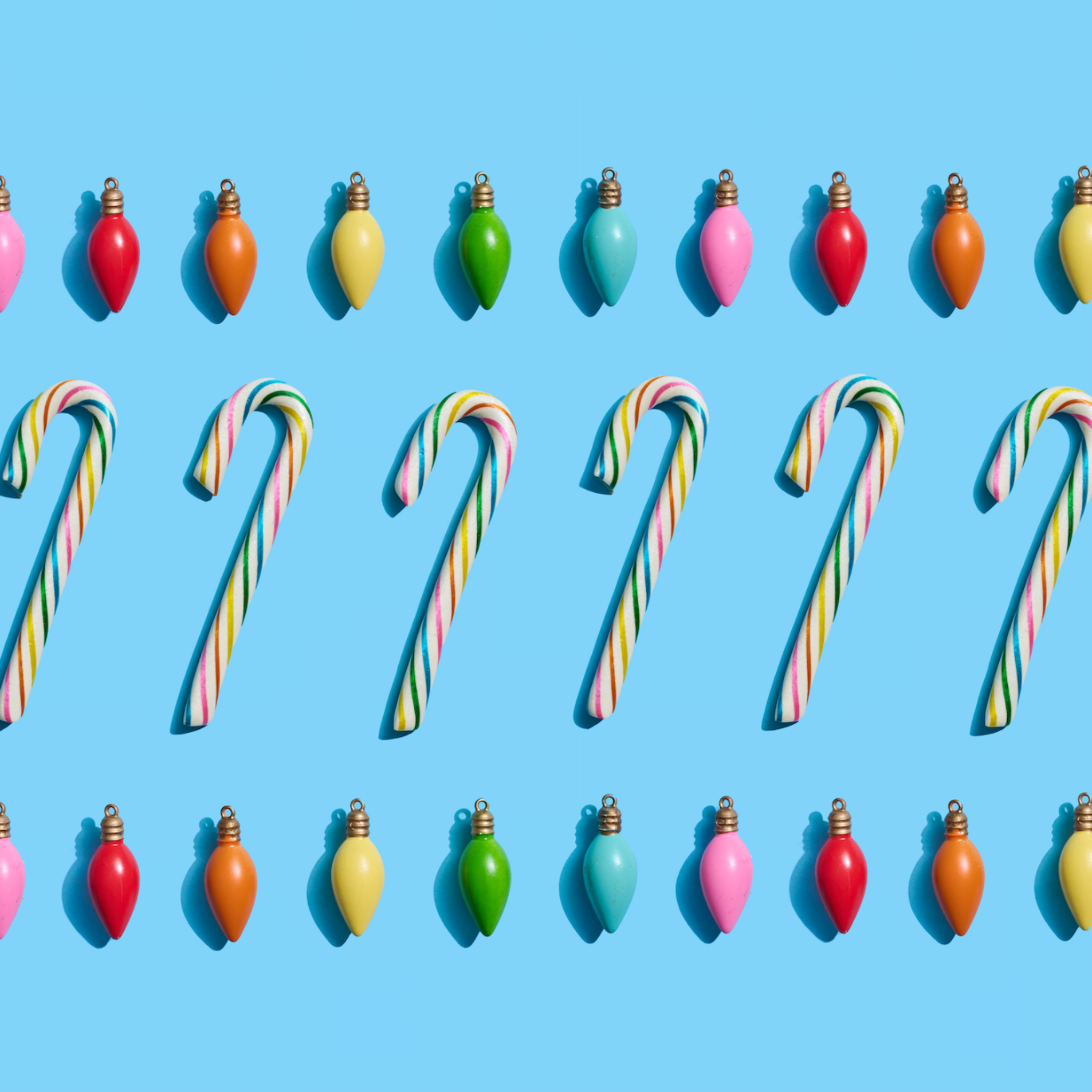 Birthday cake candy cones with colorful lightbulbs on blue background