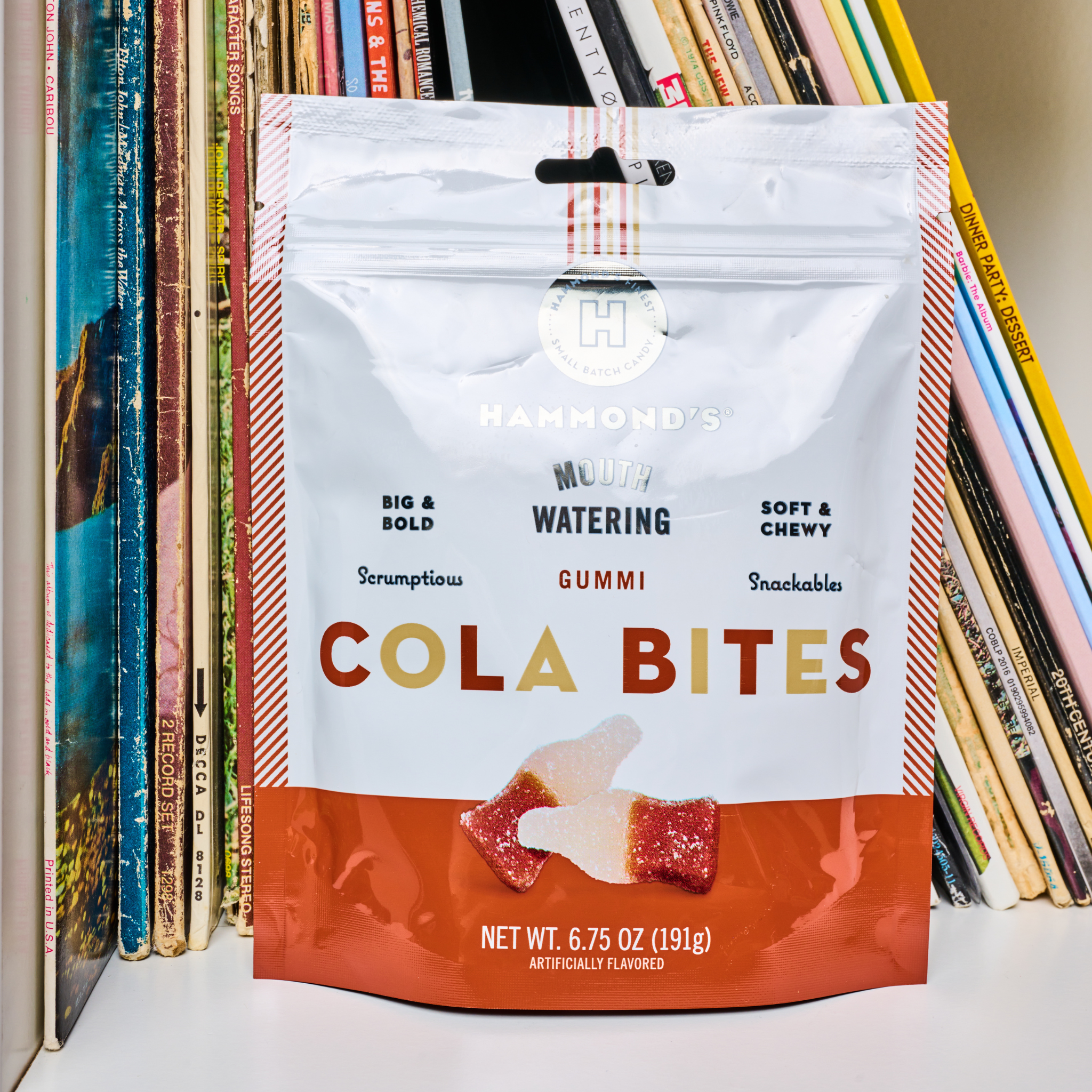 Cola Bites on bookshelf with magazines