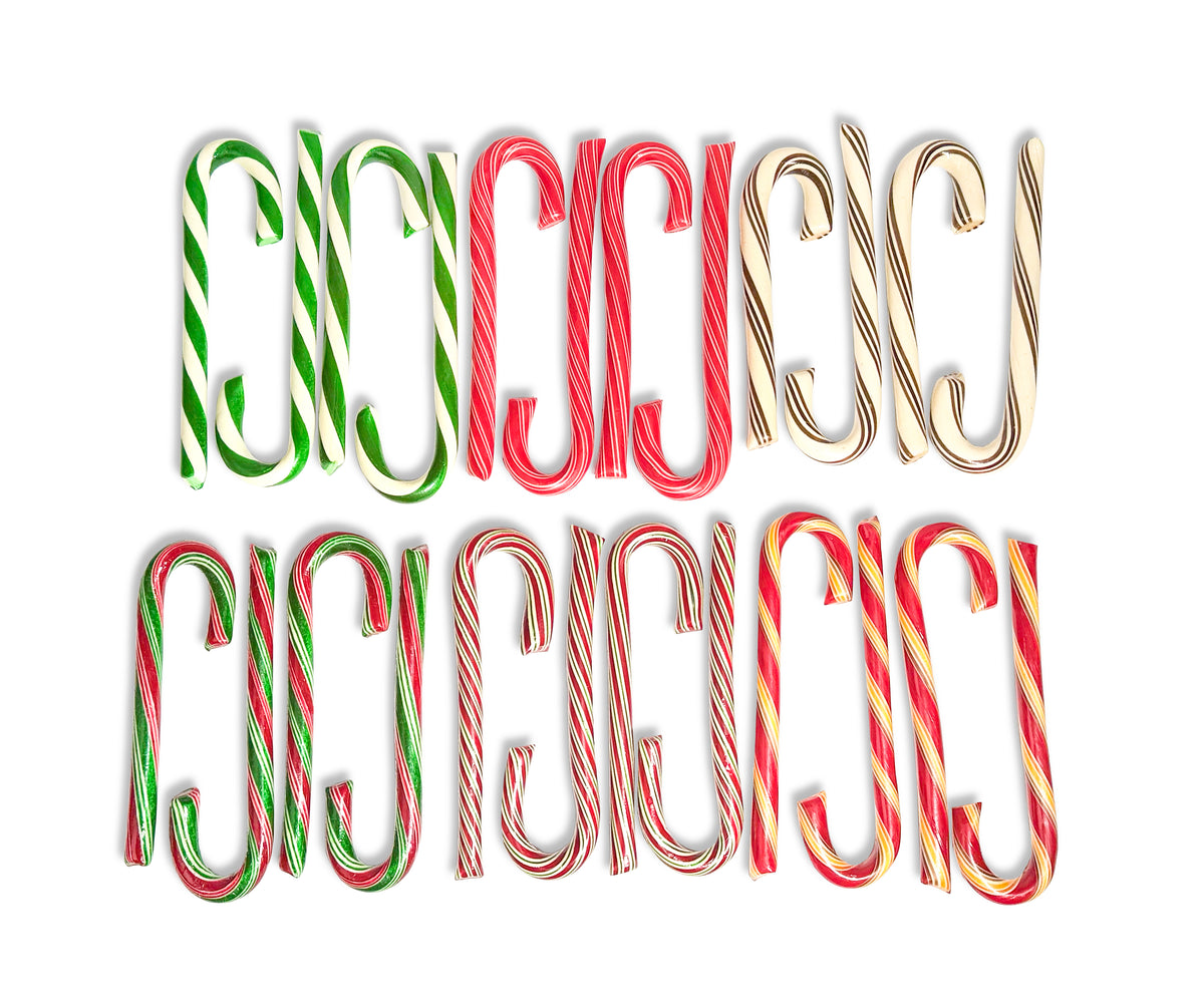 The word 'MERRY' is spelled out in large decorative letters shaped like candy canes, shown in three color variants: green and white, red and white, and red, white, and gold. The letters are arranged in two rows on a plain white background.