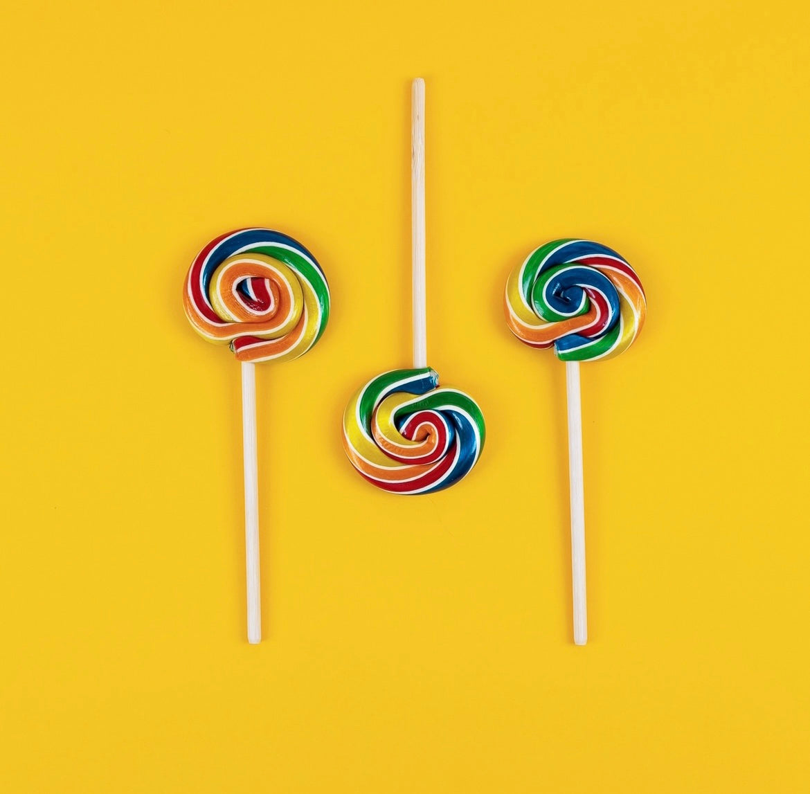 Hammond's Rainbow Blast Lollipops on Yellow Background
