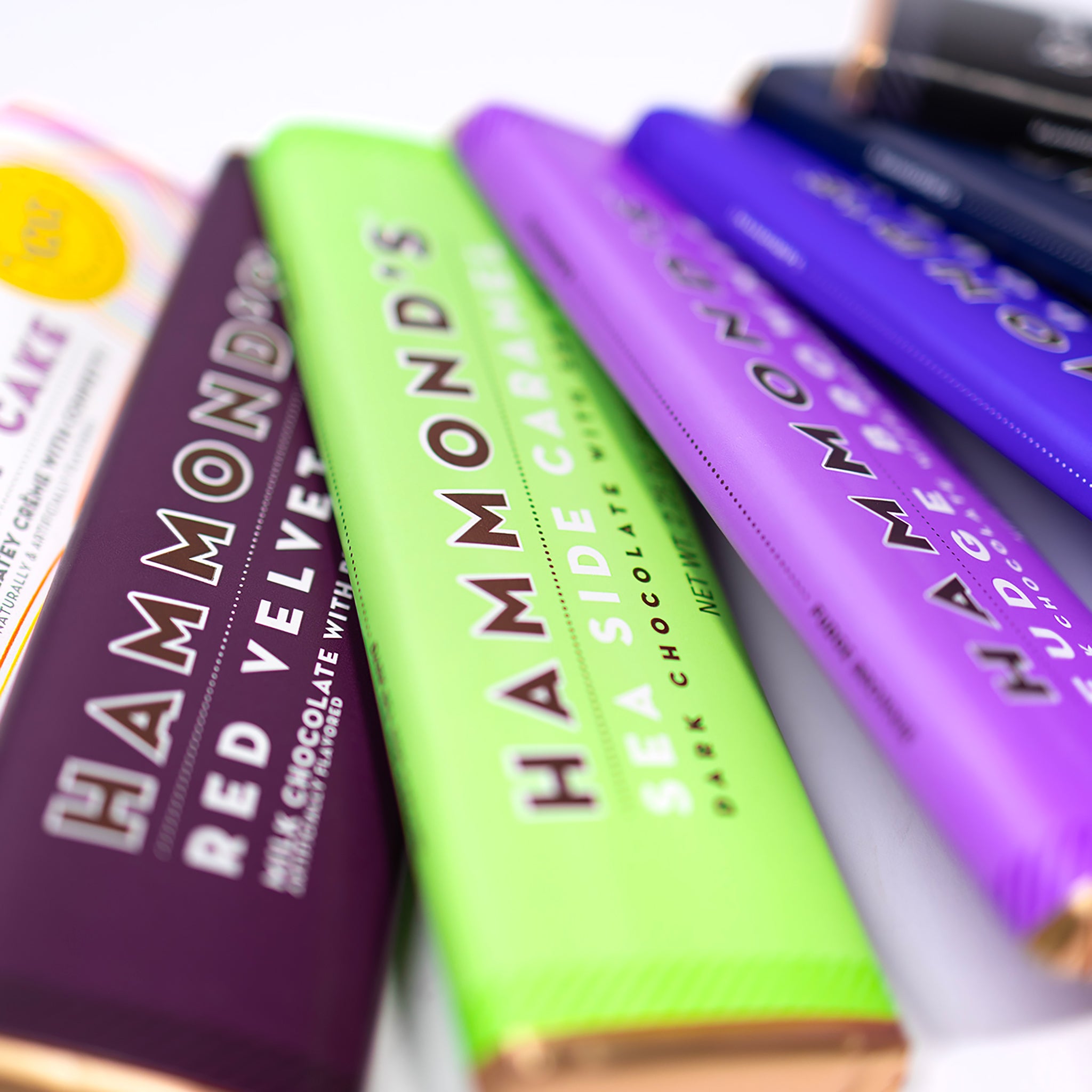 Close-up of various chocolate bars with visible branding on a white background