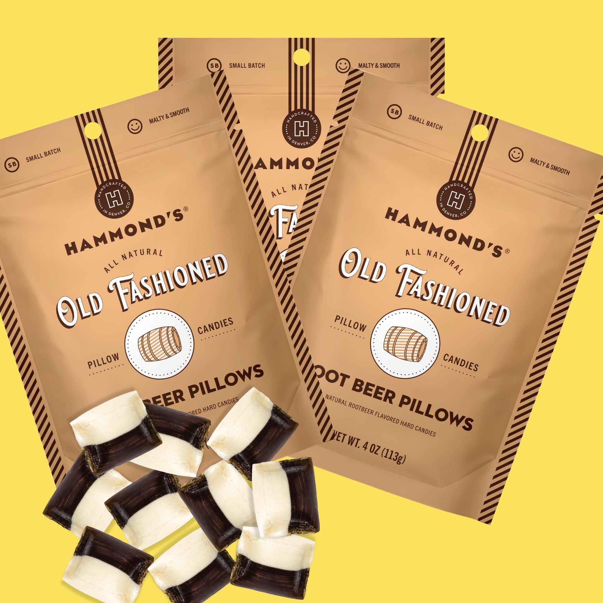 Three bags of Hammond's Old Fashioned Pillow Candies arranged on a bright yellow background, with several loose dark-and-cream candy pieces placed in front.