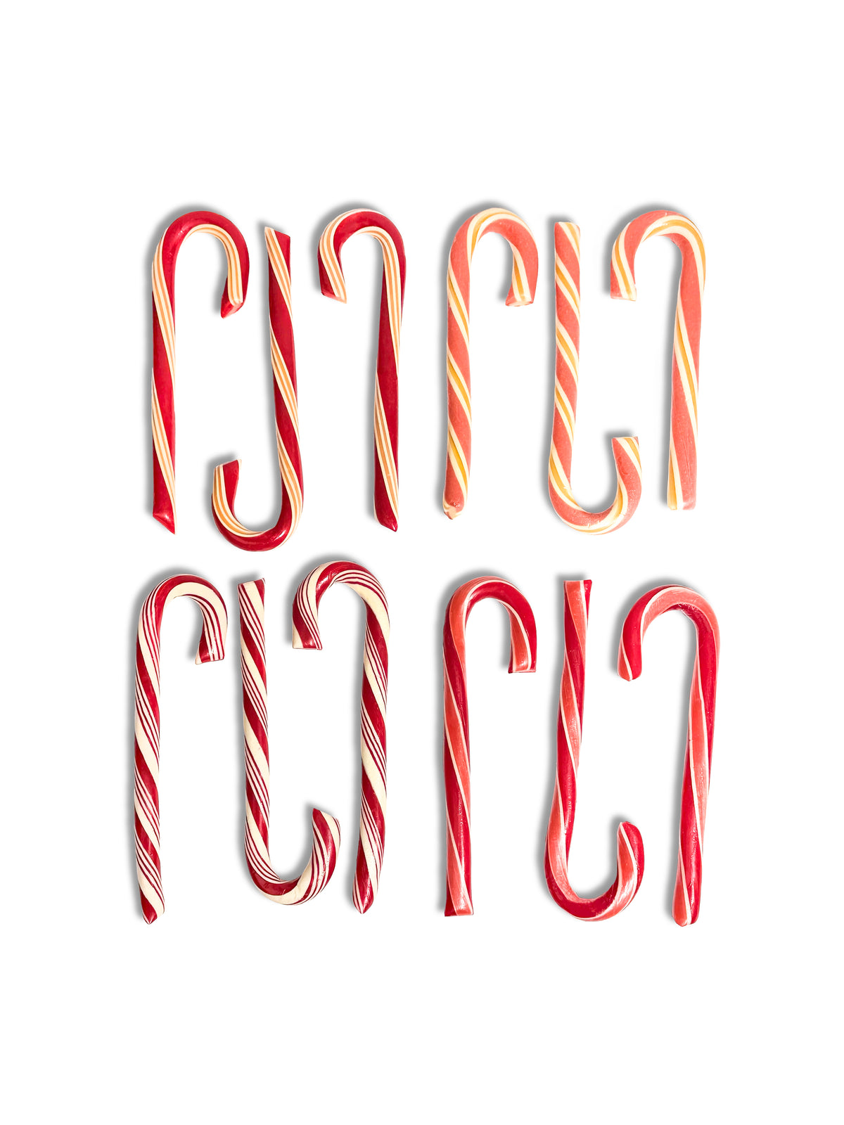 Six red and white striped candy canes arranged in two rows of three on a plain white background.