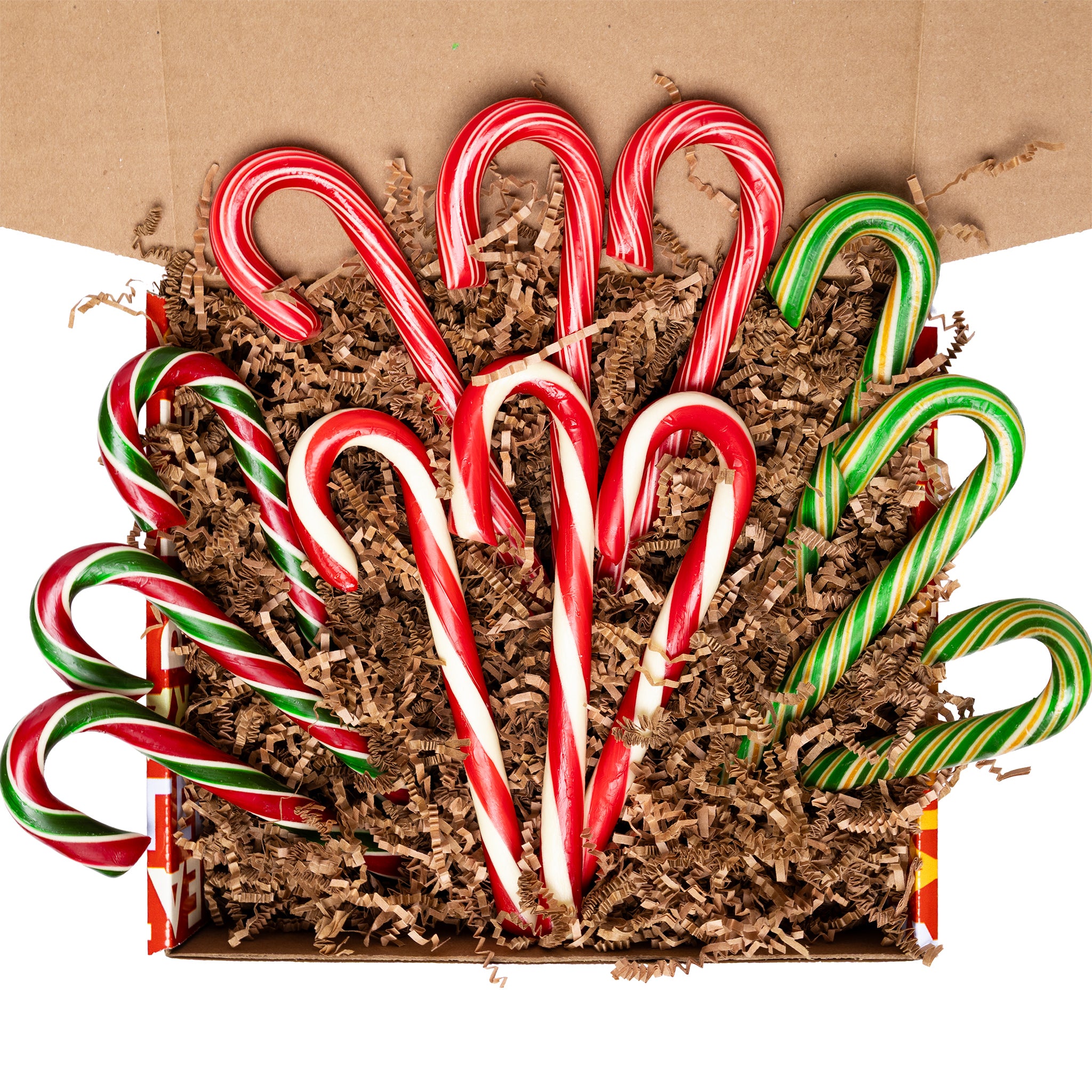 Box of candy canes with red, green, and white stripes on a brown background