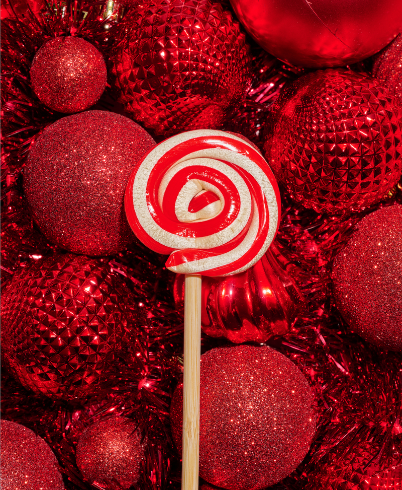 Peppermint Lollipop on top of Christmas Ornaments
