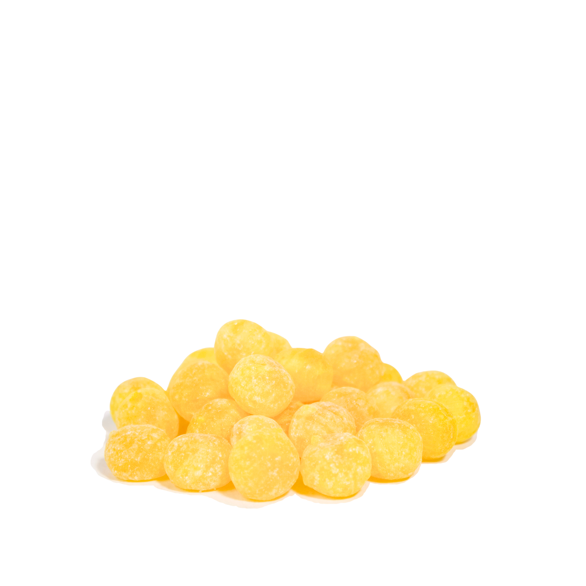 Yellow Lemon Drop candies on a white background