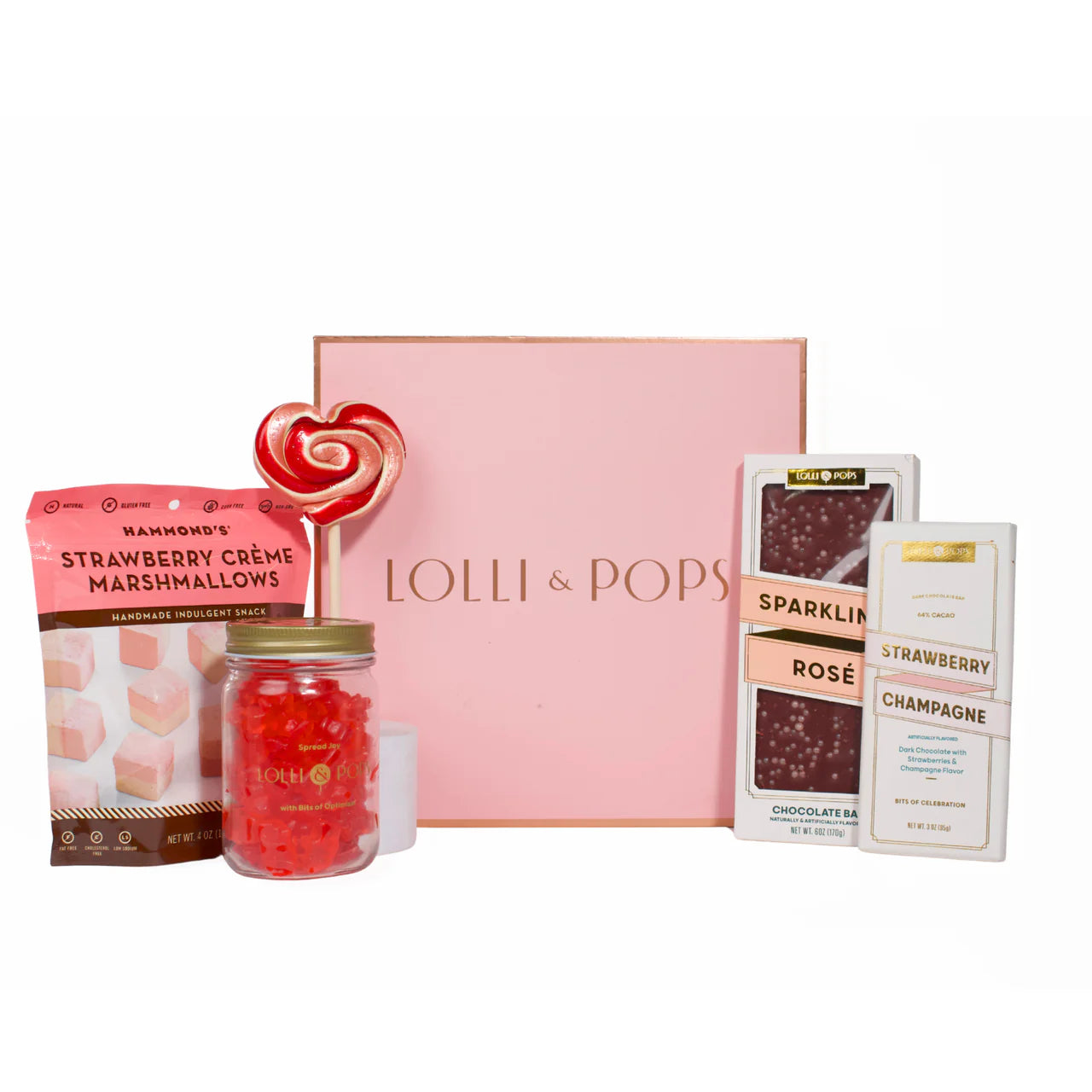 Strawberry marshmallows, lollipop, and gummy bears paired with two chocolate bars on white background with pink gift box